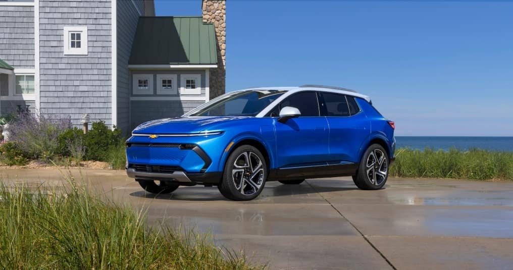 A sleek Chevy Equinox EV parked, showcasing its modern design and electric capabilities in a vibrant urban setting