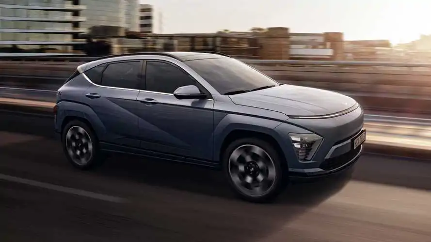 A sleek 2024 Hyundai Kona showcasing its modern design and vibrant color, parked against a scenic urban backdrop.