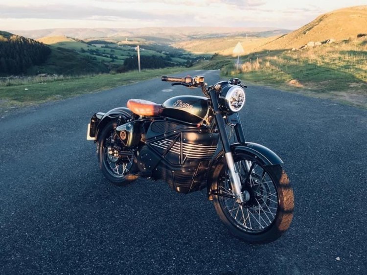 A Royal Enfield electric motorcycle parked on the roadside, showcasing its sleek design and modern features.